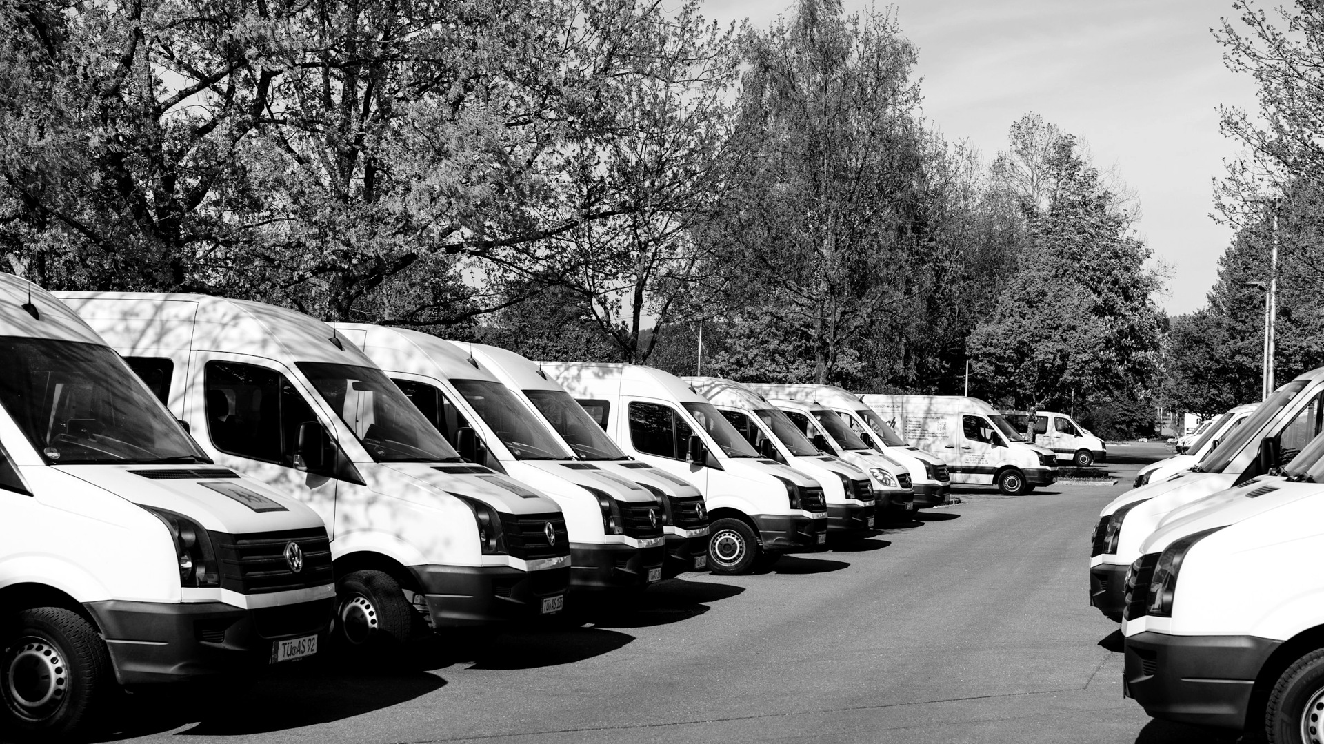 A row of white vans parked in a lot in Mössingen, Germany.
