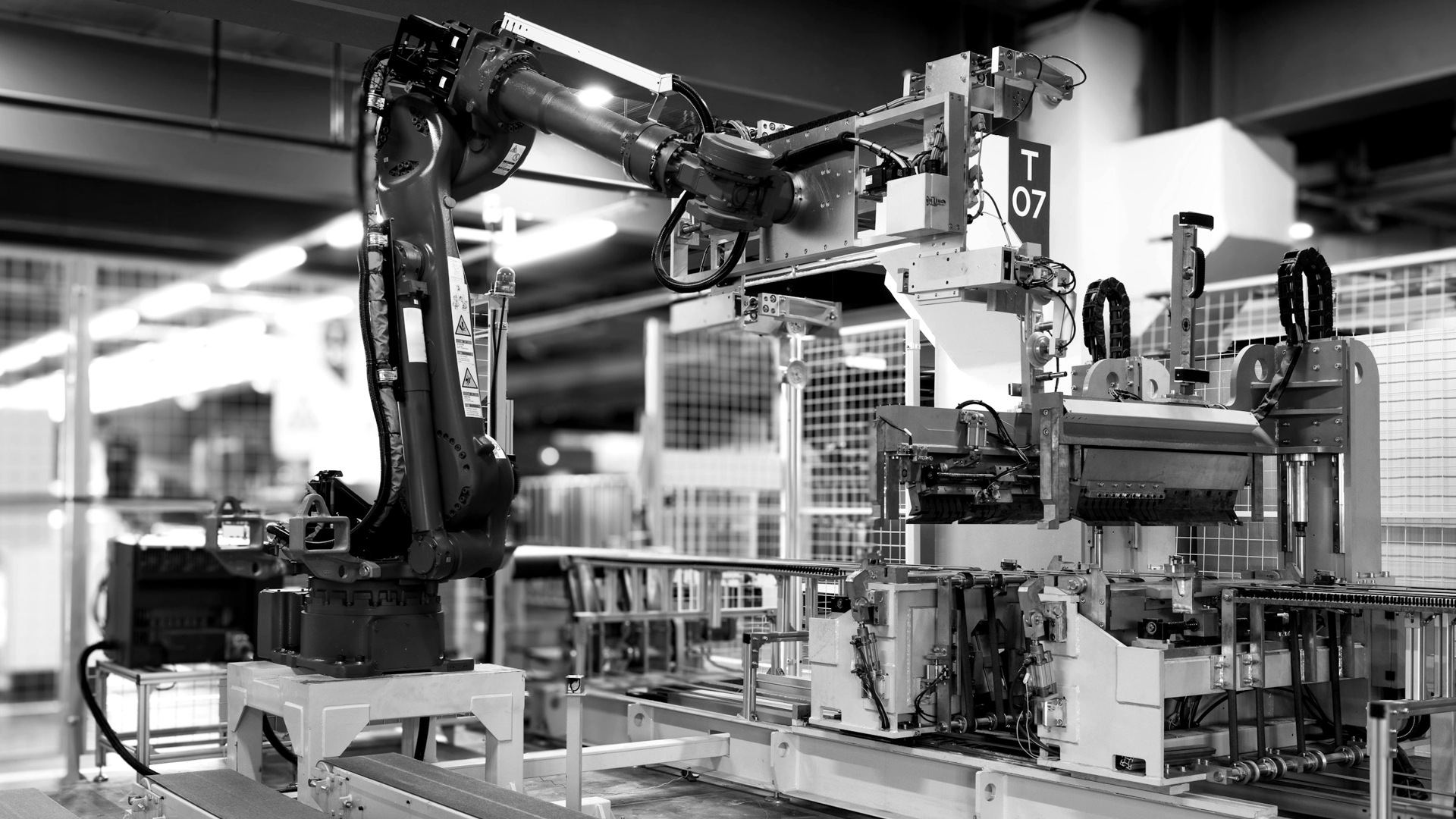 Blue industrial robot arm in factory.