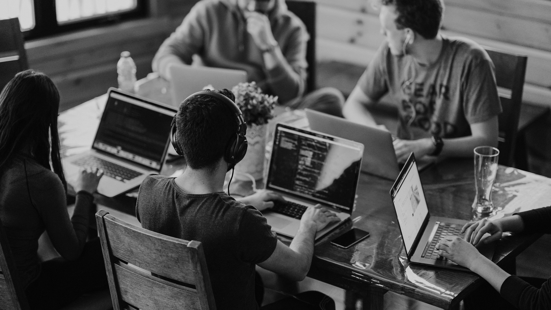 Group of people using laptop computer.