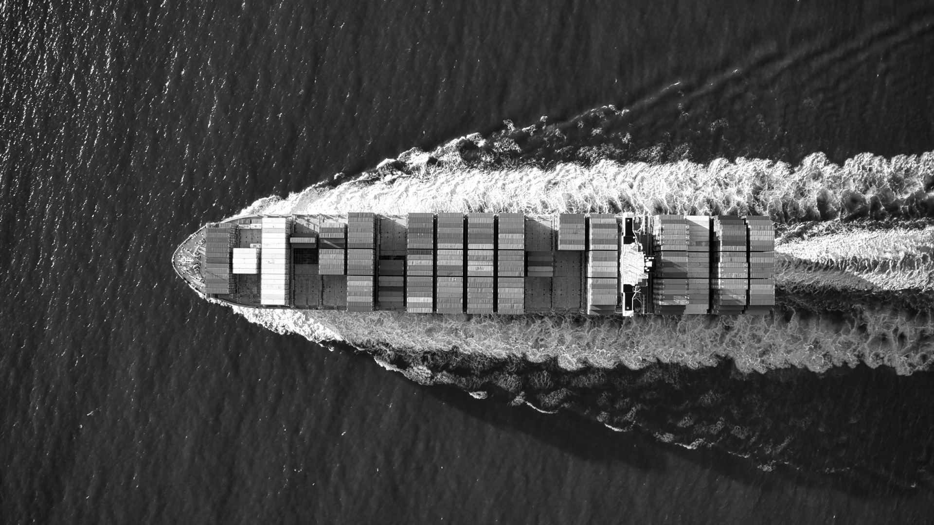 Aerial view of blue and white boat on body of water during daytime.