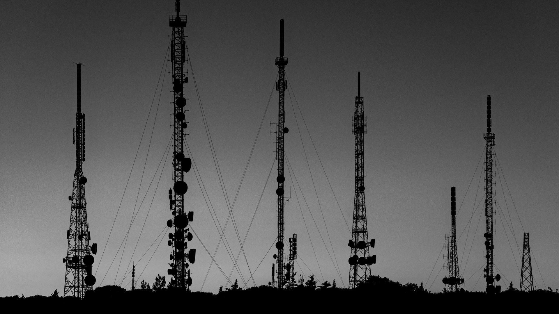 Black towers during sunset.