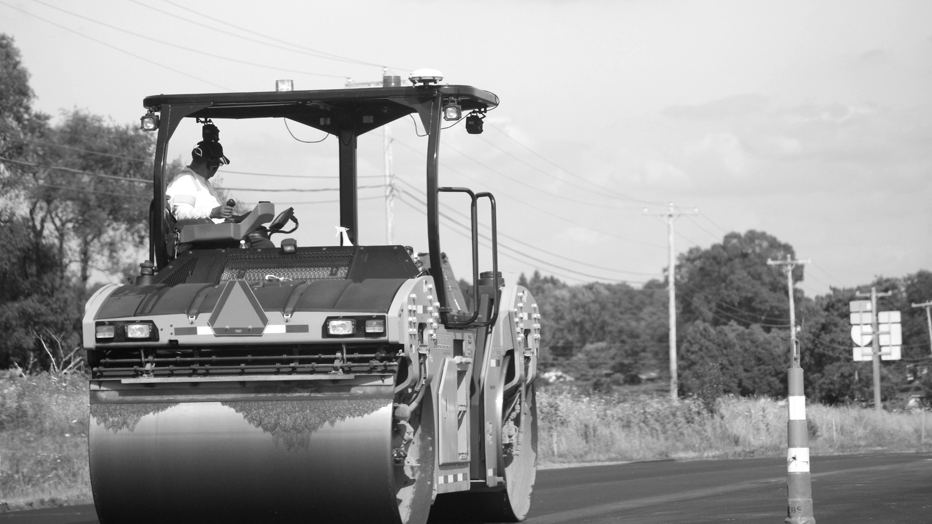Yellow and black heavy equipment on road during daytime.