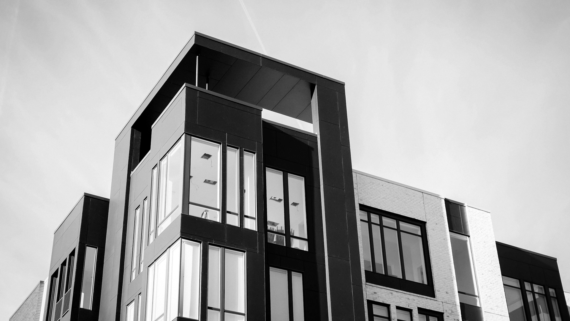 Black and white cocnrete building low-angle photography.
