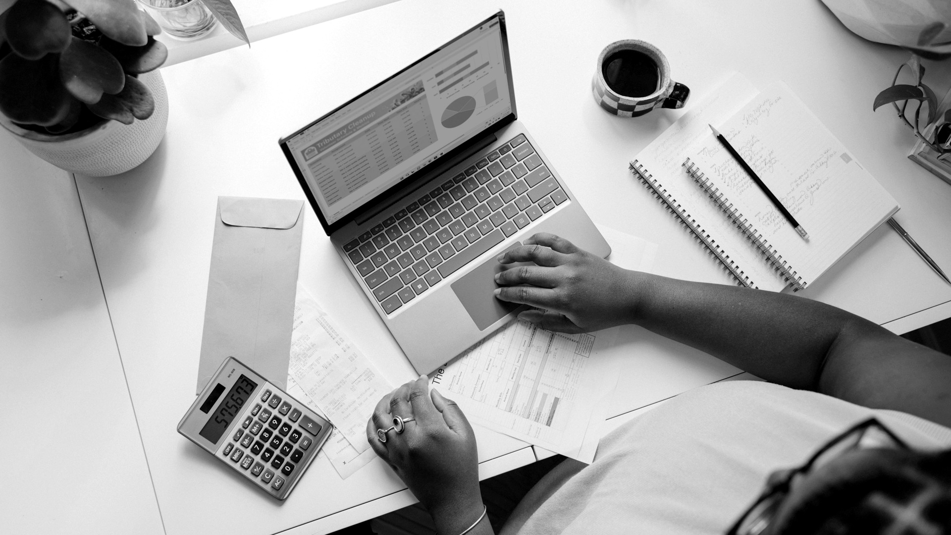 A person sitting at a table with a laptop.