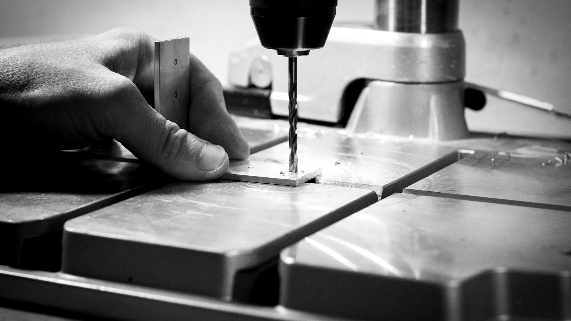 Metal Solutions marketing & GTM growth: material applications and specification-led orders 1 Person drilling metal bar.