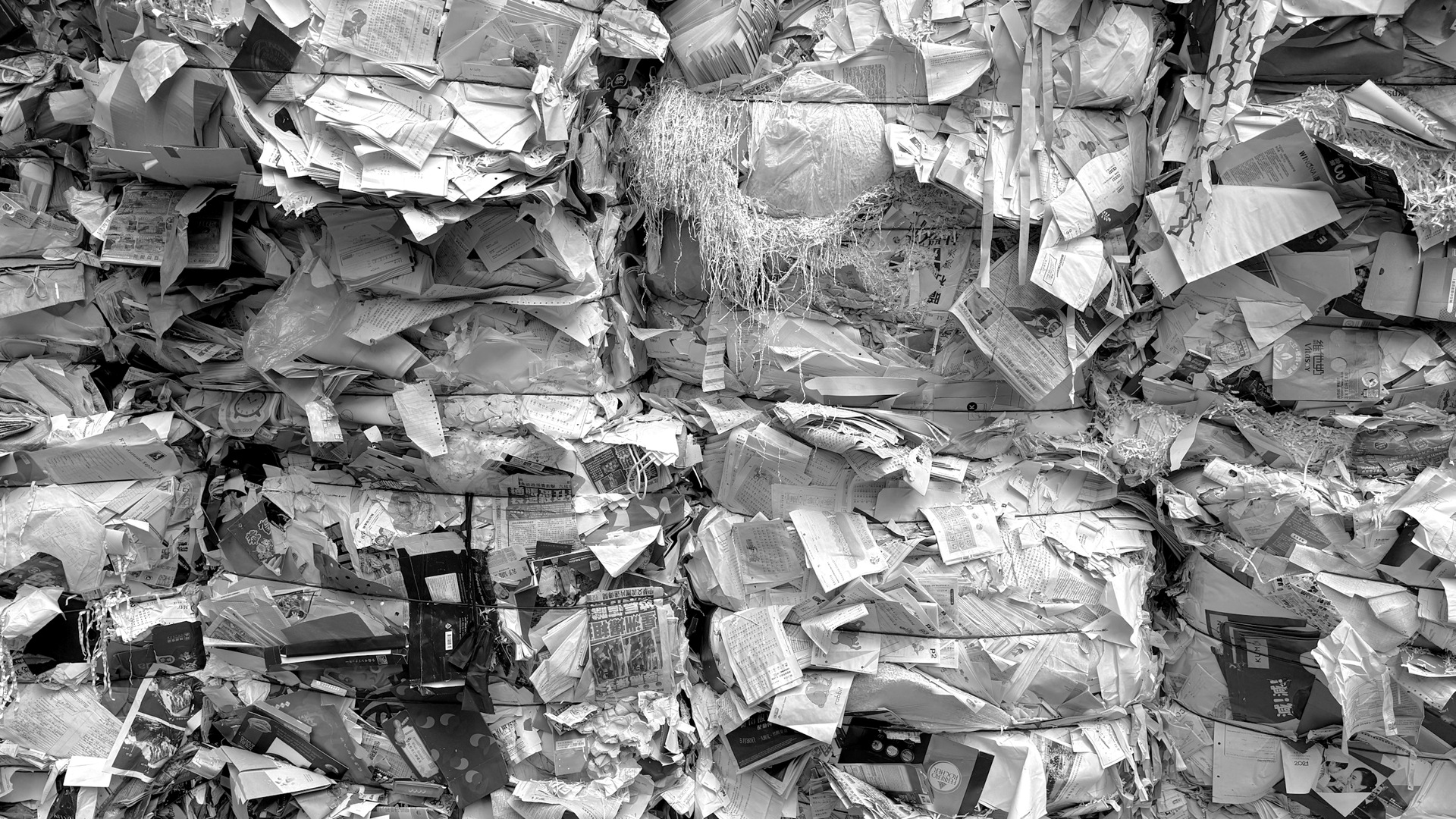 Compressed bales of mixed paper and cardboard waste.