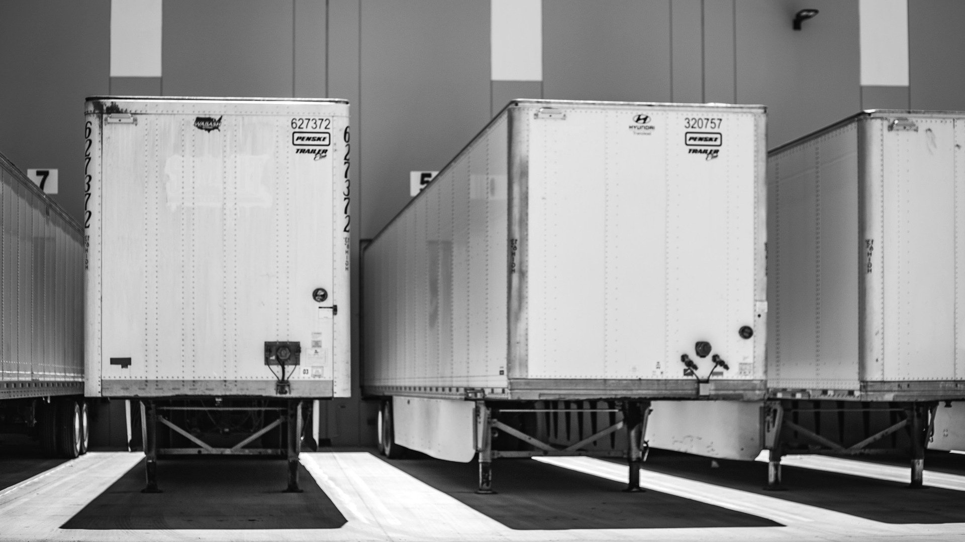 A row of semi trucks parked next to each other.