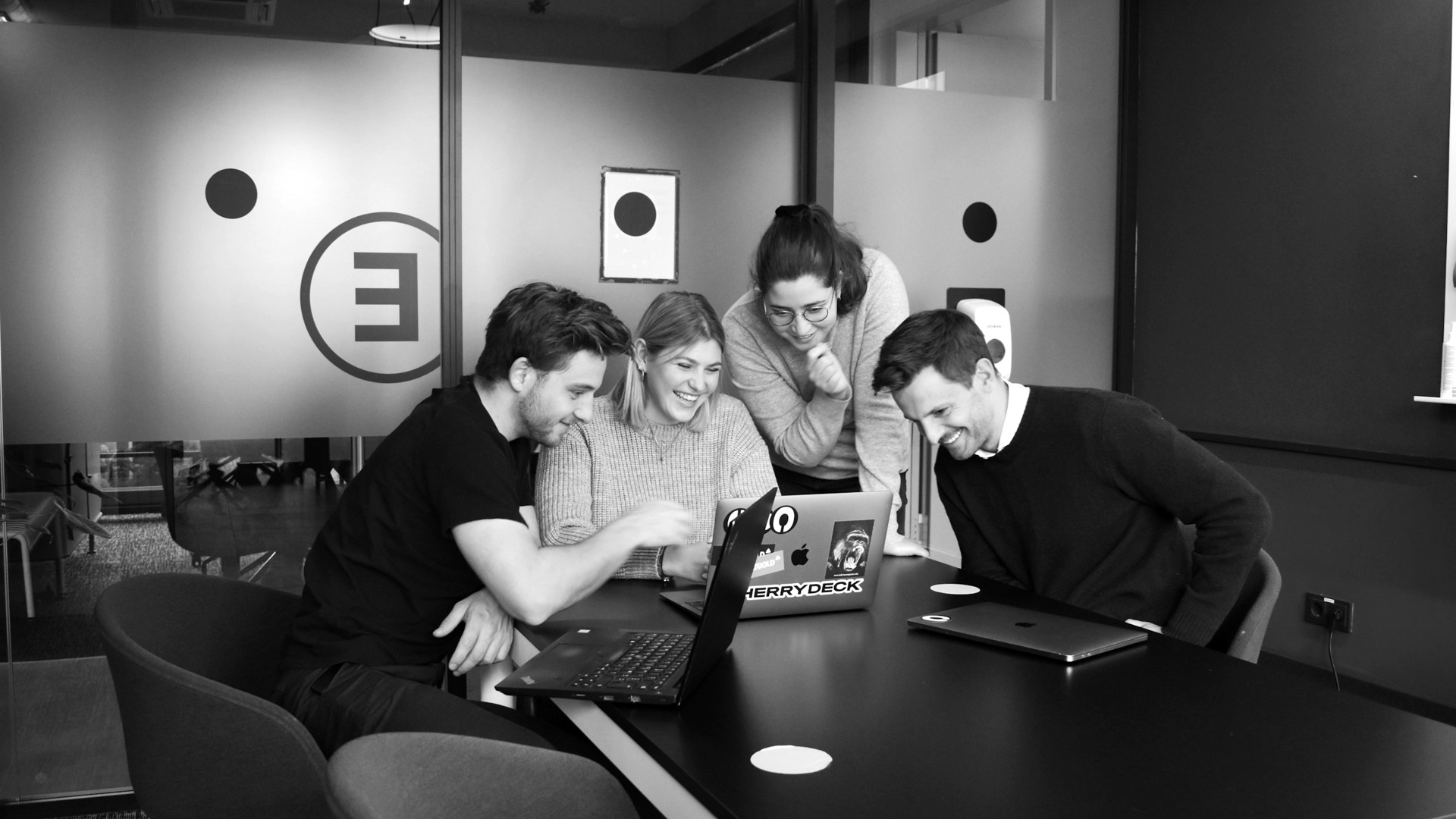 People sitting on chair in front of laptop computers.