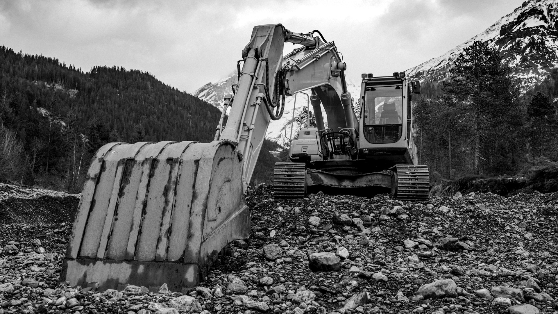 Heavy Equipment marketing & GTM growth: equipment applications and lifecycle account growth 1 Yellow and black excavator on rocky ground.